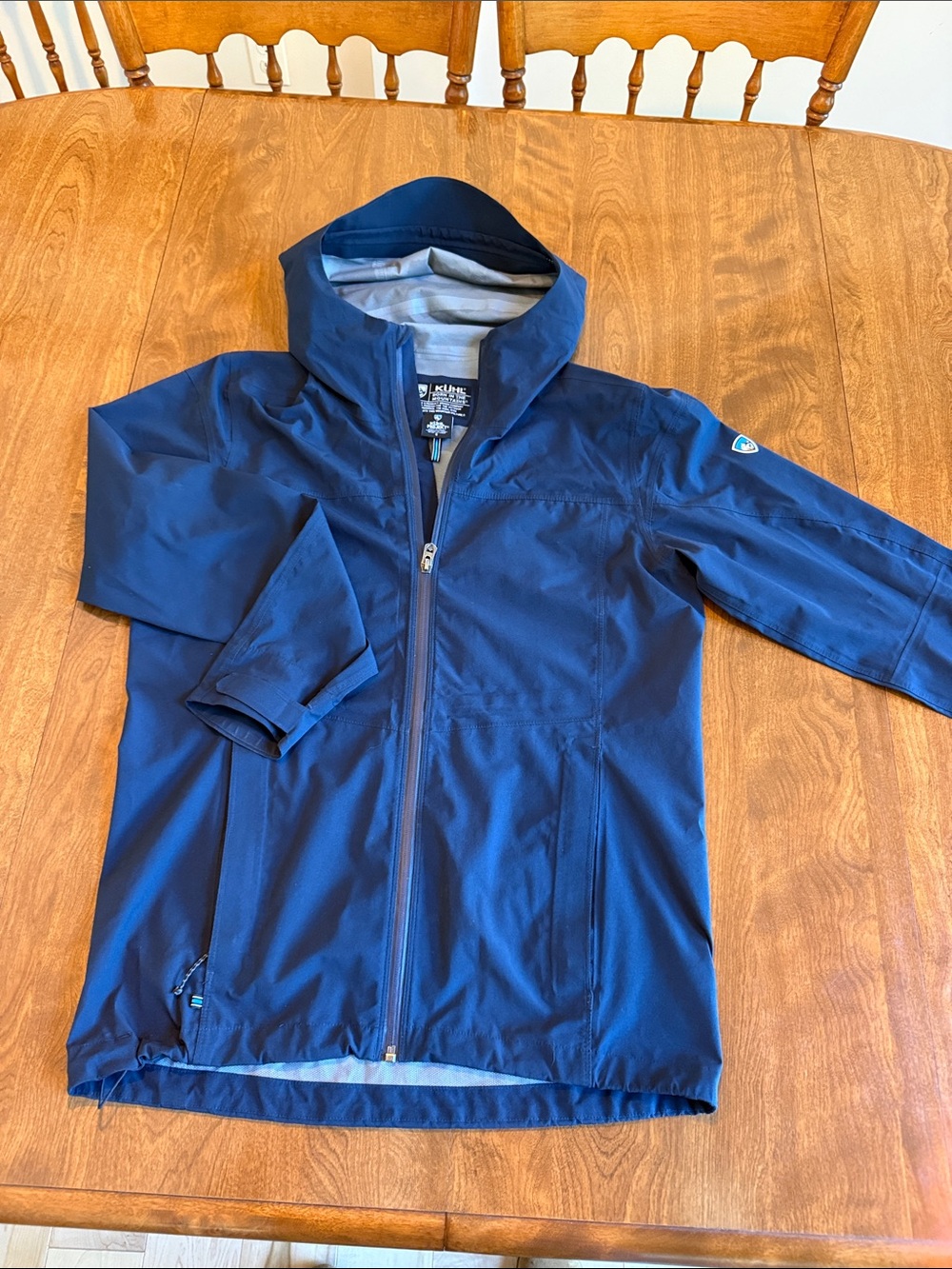 Kuhl Projekt Men's Stretch Voyagr Performance Hooded Jacket in navy.